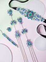 H U CINTO BRETELERA ANILLO Y PULSERA LA SIRENITA EN MESA